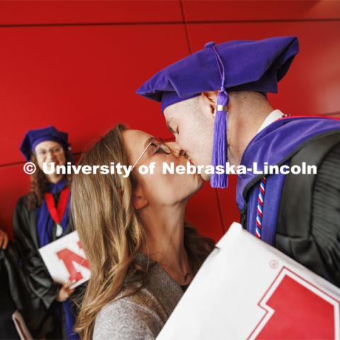 Grant Jones, kissed his wife, Mikayla, following the ceremony. Mikayla will be a third-year Nebraska Law student in the fall. College of Law commencement in Devaney on the volleyball court. May 3, 2024. Photo by Craig Chandler / University Communication and Marketing.