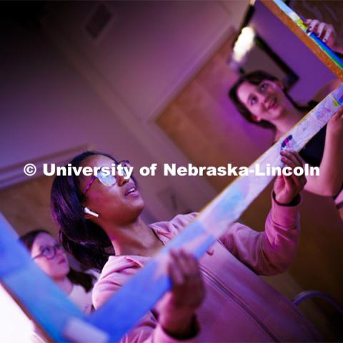 Jakaya Bedford, left, and Jillian Rodgers attach a frame to a video screen. Students in the Carson Emerging Media Arts building work on their projects in preparation for Friday’s Spring 2024 Open Studios event at the center. May 8, 2024. Photo by Craig Chandler / University Communication and Marketing.