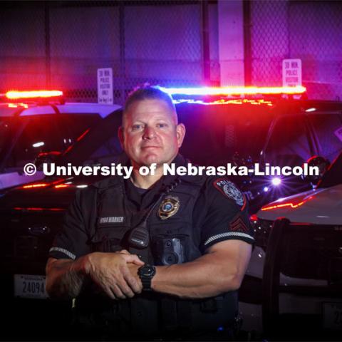 UNL Police Department Sargent Bryan Warner poses in front of his police cruiser. May 8, 2024. Photo by Craig Chandler / University Communication and Marketing.