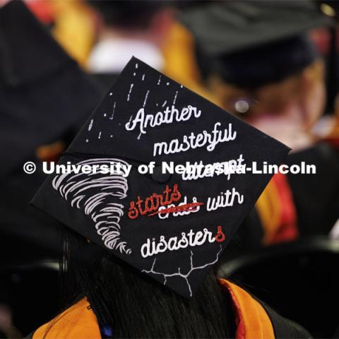 One decorated mortarboard reads “Another masterful attempt starts with disasters” at Graduate Commencement. May 17, 2024. Photo by Craig Chandler / University Communication and Marketing.