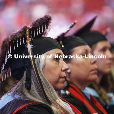 Tracy Rene’e Hartman-Bradley listens to welcoming comments by the chancellor. Hartman-Bradley is part of the first cohort of the Indigenous Roots Teacher Education Program to receive masters degrees. She is a member of the Sugpiaq tribe. Graduate Commencement. May 17, 2024. Photo by Craig Chandler / University Communication and Marketing.