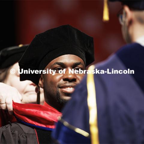 Michael Tross receives his doctoral hood assisted by Professor James Schnable. Graduate Commencement. May 17, 2024. Photo by Craig Chandler / University Communication and Marketing.