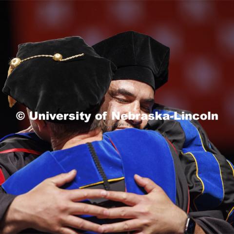 Maika Malualeilagi Tuala hugs professor Regina Werum after receiving his doctoral degree. The Samoan had a large cheering section of family and friends. Graduate Commencement. May 17, 2024. Photo by Craig Chandler / University Communication and Marketing.