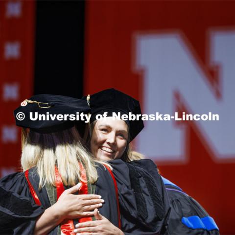 Nicole Weyers is hugged by Professor Stacie Ray after she received doctor of audiology hood. Graduate Commencement. May 17, 2024. Photo by Craig Chandler / University Communication and Marketing.