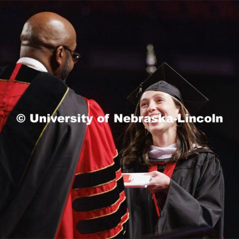 Graduate receives her diploma from Chancellor Bennett at Graduate Commencement. May 17, 2024. Photo by Craig Chandler / University Communication and Marketing.