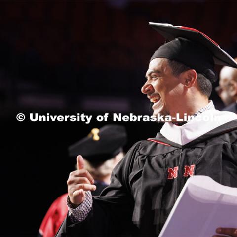 Raymond Ramirez smiles to the platform party after receiving his masters degree. Graduate Commencement. May 17, 2024. Photo by Craig Chandler / University Communication and Marketing.