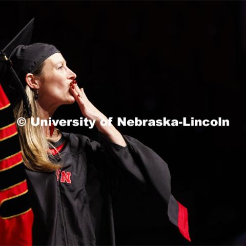 Lindsey Coleman blows a kiss to her family and friends. Graduate Commencement. May 17, 2024. Photo by Craig Chandler / University Communication and Marketing.