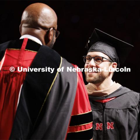 Chancellor Bennett congratulates a graduate at Graduate Commencement. May 17, 2024. Photo by Craig Chandler / University Communication and Marketing.