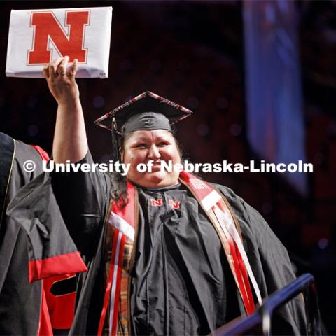 Newly graduated and proudly showing off their diploma at Graduate Commencement. May 17, 2024. Photo by Craig Chandler / University Communication and Marketing.