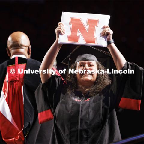 Newly graduated and proudly showing off their diploma at Graduate Commencement. May 17, 2024. Photo by Craig Chandler / University Communication and Marketing.