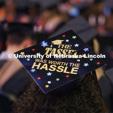 Bella Rodriguez lets the world know she’s proud of her master’s degree with her decorated mortarboard that reads “The tassel was worth the hassle”. Graduate Commencement. May 17, 2024. Photo by Craig Chandler / University Communication and Marketing.