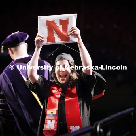 Karolayn Greys Chavez Loor celebrates and shows her Masters of Architecture diploma to family and friends. Graduate Commencement. May 17, 2024. Photo by Craig Chandler / University Communication and Marketing.