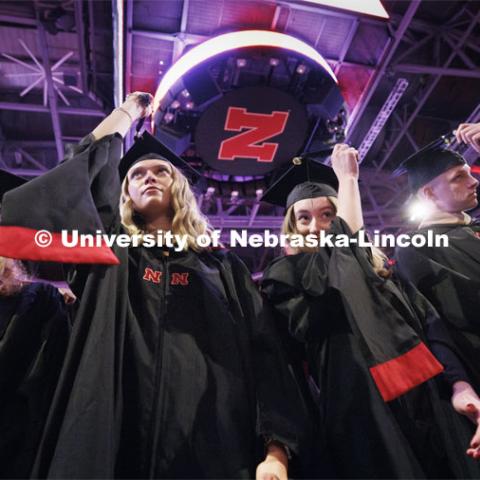 Kimberly Osborn, Kaylee Pekarek, Lisa Peterson and Scott Peterson move their tassels at to celebrate their commencement. Graduate Commencement. May 17, 2024. Photo by Craig Chandler / University Communication and Marketing.