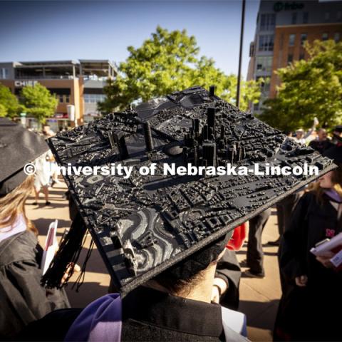 Jacob Granger, a masters student in architecture, 3-D printed a city scape for his mortarboard. Graduate Commencement. May 17, 2024. Photo by Craig Chandler / University Communication and Marketing.
