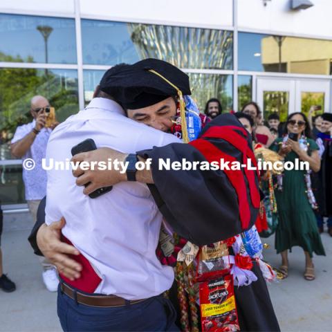 Maika Malualeilagi Tuala hugs his brother, Sone Tuala, after Sone performed a Haka, a south pacific chant, to honor his brother receiving his doctoral degree. The Samoan had a large cheering section of family and friends. Graduate Commencement.. May 17, 2024. Photo by Craig Chandler / University Communication and Marketing