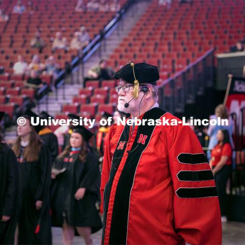 Dr. Robert Gorman watches UNL’s graduate students as they walk to their seats. May 17, 2024. Photo by Kristen Labadie / University Communication.