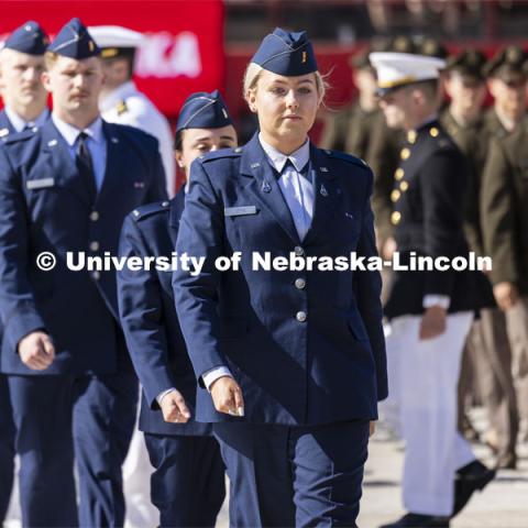 Nineteen ROTC cadets including Air Force Second Lieutenant Taylor Ziepke of Omaha approach the stage to recite their commissioning oath in front of the commencement stage. The actual military and naval commissions have been done over the past couple of days, but the group repeated their oath for the ceremony. Undergraduate Commencement in Memorial Stadium. May 18, 2024. Photo by Craig Chandler / University Communication and Marketing.