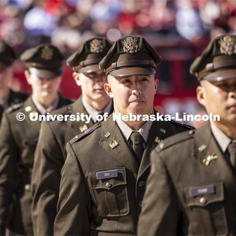 Nineteen ROTC cadets including Army Second Lieutenant Daniel Do of Lincoln approach the stage to recite their commissioning oath in front of the commencement stage. The actual military and naval commissions have been done over the past couple of days, but the group repeated their oath for the ceremony. Undergraduate Commencement in Memorial Stadium. May 18, 2024. Photo by Craig Chandler / University Communication and Marketing.