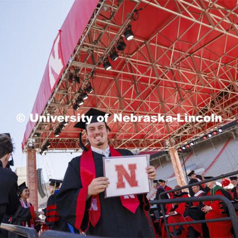 A grad smiles after receiving his diploma. Undergraduate Commencement in Memorial Stadium. May 18, 2024. Photo by Craig Chandler / University Communication and Marketing.
