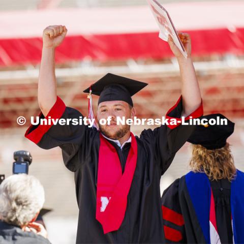 Michael Walters cheers after receiving his marketing degree from the College of Business. Undergraduate Commencement in Memorial Stadium. May 18, 2024. Photo by Craig Chandler / University Communication and Marketing.