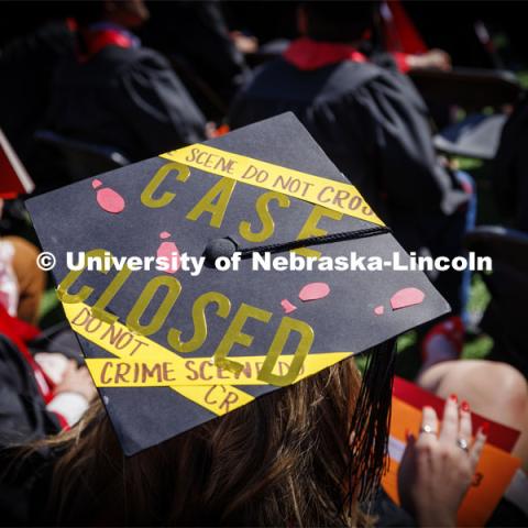 One graduate’s mortar board was decorated with crime scene tape reading "Case Closed". Undergraduate Commencement in Memorial Stadium. May 18, 2024. Photo by Craig Chandler / University Communication and Marketing.