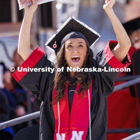 Kelsie Bliss celebrates as she sees herself on the HuskerVision screen after receiving her degree. Undergraduate Commencement in Memorial Stadium. May 18, 2024. Photo by Craig Chandler / University Communication and Marketing.