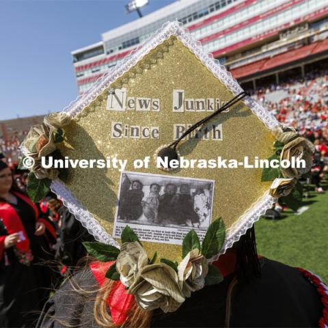 Alyssa Huber was featured in the Lincoln Journal Star as a newborn and will now work for the newspaper after graduating with her journalism degree. Huber’s mortar board is decorated with newsprint flowers, a photo and cutout letters from a newspaper. Undergraduate Commencement in Memorial Stadium. May 18, 2024. Photo by Craig Chandler / University Communication and Marketing.