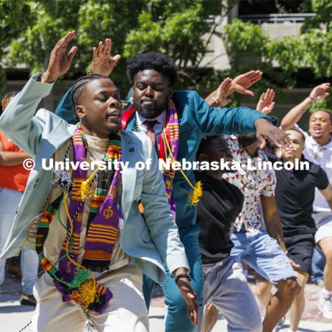 Gordon Taylor and Wil Koumaka celebrate their graduation by dancing with their Omega Psi Phi fraternity brothers outside Memorial Stadium. Undergraduate Commencement in Memorial Stadium. May 18, 2024. Photo by Craig Chandler / University Communication and Marketing.
