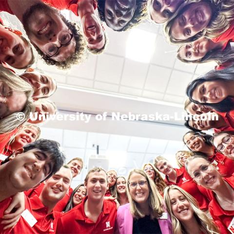 Jenni Brost, Director of New Student Enrollment (in pink jacket), and the NSE Orientation Leaders huddle up during one of their last training sessions. New Student Enrollment. May 23, 2024. Photo by Craig Chandler / University Communication and Marketing.