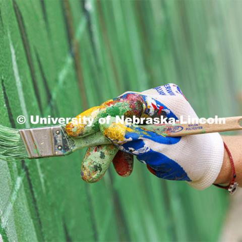 Blades of grass are painted as part of the mural. ARTS 398 - Special Topics in Studio Art III taught by Sandra Williams. The class painted a mural at the Premier Buick, Chevrolet, and GMC dealership in Beatrice. June 3, 2024. Photo by Craig Chandler / University Communication and Marketing.