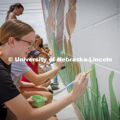 Middle School student Morgan Nielsen as community members helped paint Tuesday. ARTS 398 - Special Topics in Studio Art III taught by Sandra Williams. The class painted a mural at the Premier Buick, Chevrolet, and GMC dealership in Beatrice. June 3, 2024. Photo by Craig Chandler / University Communication and Marketing.