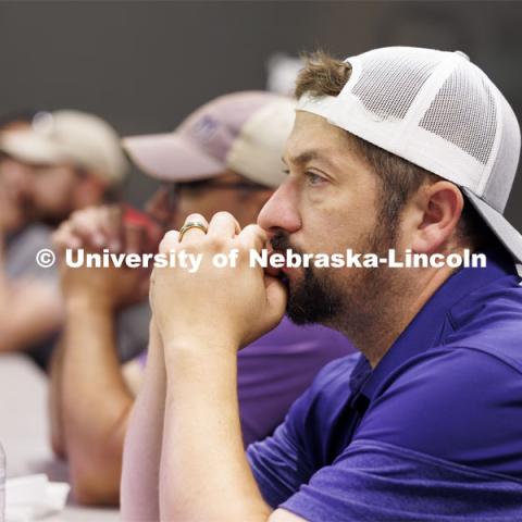 Nick Restau from Milford Public Schools listens as Travis Ray from Nebraska Innovation Studios goes over aviation charts. Ray is teaching drone classes so people can get their p107 license to fly. June 18, 2024. Photo by Craig Chandler / University Communication and Marketing.