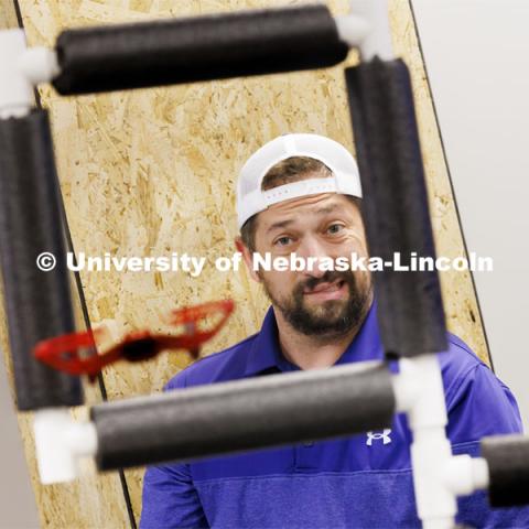 Concentration shows on Nick Restau’s face as he tries to pilot a small UAV through an obstacle course at Nebraska Innovation Studio. Restau, from Milford Public Schools, is one of several teachers training to get their drone license in a class taught by Travis Ray from Nebraska Innovation Studio. June 18, 2024. Photo by Craig Chandler / University Communication and Marketing.