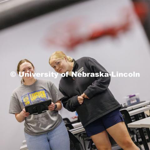 Rebecca Wulf (left), who graduated in agriculture education and will teach this fall at Lakeview Community Schools near Columbus, and Taryn Miller, a senior in agriculture education from Amherst, Nebraska, fly a drone through an obstacle course at Nebraska Innovation Studio. The two are taking the class at Nebraska Innovation Studio to get their FAA license to fly UAVs. June 18, 2024. Photo by Craig Chandler / University Communication and Marketing.