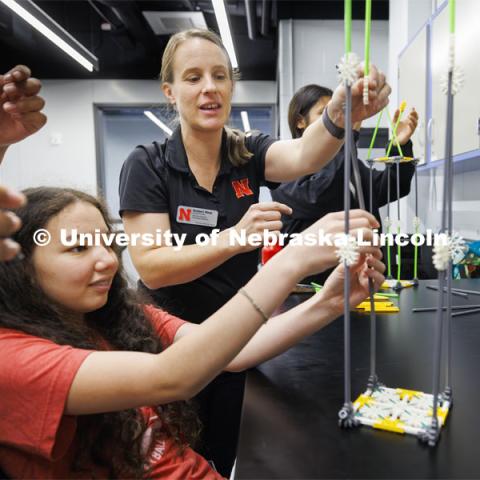 Christine Wittich, Assistant Professor in Civil and Environmental Engineering, helps Eve Chavez build a tower to be tested on the shake table. Sovereign Native Youth STEM Leadership Academy sponsored by MATC. June 24, 2024. Photo by Craig Chandler / University Communication and Marketing.