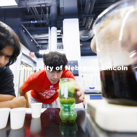 Zach Abourezk, center and Mike Cayou, Jr., watch water slowly drip through a filter to improve its quality during a group’s environmental lab experiment. Sovereign Native Youth STEM Leadership Academy sponsored by MATC. June 24, 2024. Photo by Craig Chandler / University Communication and Marketing.