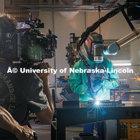 Filming Nebraska Innovation Studios welding robot. Behind the scenes photo for the university's new "Home Again" national advertisement. June 25, 2024. Photo by Kristen Labadie / University Communication.   