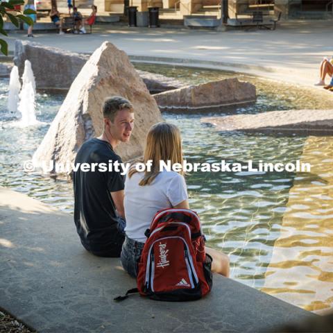 Students relaxing by Broyhill Fountain. On campus filming. Behind the scenes photo for the university's new "Home Again" national advertisement. June 25, 2024. Photo by Kristen Labadie / University Communication.   