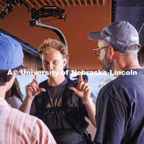 A film crew records downtown Omaha. Behind the scenes photo for the university's new "Home Again" national advertisement. June 26, 2024. Photo by Kristen Labadie / University Communication.   