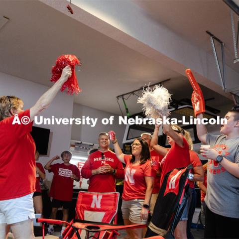 A film crew records a garage husker watch party in Omaha. Behind the scenes photo for the university's new "Home Again" national advertisement. June 26, 2024. Photo by Kristen Labadie / University Communication.   