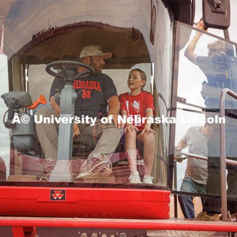 Filming a tractor in the field. Farming scenes. Behind the scenes photo for the university's new "Home Again" national advertisement. June 26, 2024. Photo by Kristen Labadie / University Communication.   