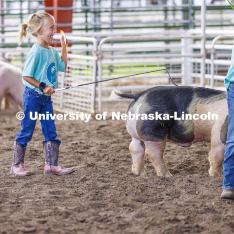 Ivy Mentink, 5, shows off her Clover Kids ribbon to family and friends. 4-H Polk County Fair in Osceola, Nebraska. July 19, 2024.  Photo by Craig Chandler / University Communication and Marketing.