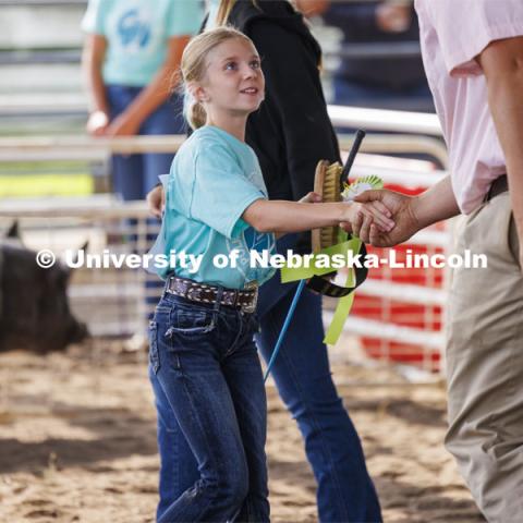 Emma Peterson of Osceola, Nebraska, shakes hands with the judge after being awarded the reserve grand champion ribbon. 4-H Polk County Fair in Osceola, Nebraska. July 19, 2024. Photo by Craig Chandler / University Communication and Marketing.