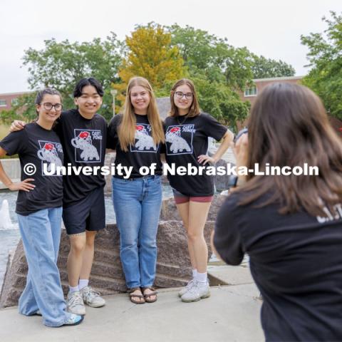 Sammy Smith, a senior in CoJMC, takes photos of CAST mentors in front of the Broyhill Fountain as they prepare for Sunday’s start of more than 300 new students in the program. City Campus. August 16, 2024. Photo by Craig Chandler / University Communication and Marketing.