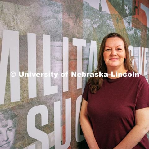 Natalie Frederick, military and VA benefits specialist at the Military and Veteran Success Center, by the mural outside the center. September 5, 2024. Photo by Kristen Labadie / University Communications.