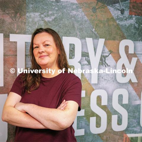 Natalie Frederick, military and VA benefits specialist at the Military and Veteran Success Center, by the mural outside the center. September 5, 2024. Photo by Kristen Labadie / University Communications.