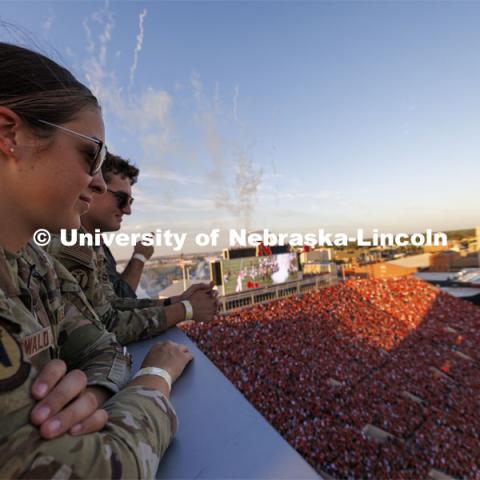 Air Force ROTC cadets Elena Burgwald and Mason Beck watch the tunnel walk from the roof of west stadium after the successful flyover. Nebraska vs. Illinois football game. September 20, 2024. Photo by Craig Chandler / University Communication and Marketing.