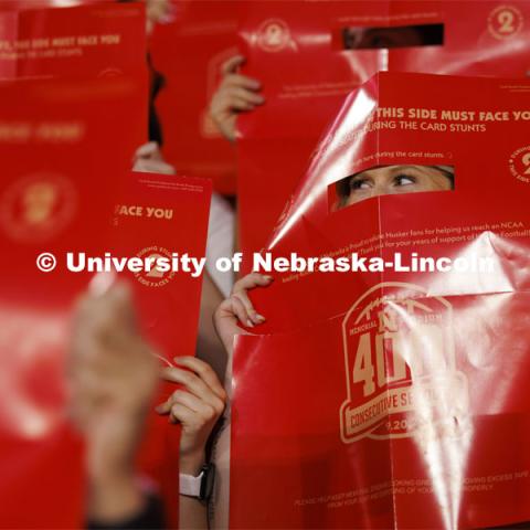 Sarah Griess looks through her flip card as the east stadium lower bowl fans spelled out a 400th consecutive sellout message. Nebraska vs. Illinois football game. September 20, 2024. Photo by Craig Chandler / University Communication and Marketing.