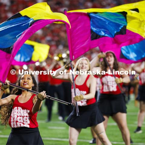 Cornhusker Marching Band Color Guard twirl their flags at the Nebraska vs. Illinois football game. September 20, 2024. Photo by Craig Chandler / University Communication and Marketing.