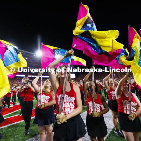 Cornhusker Marching Band Color Guard twirl their flags at the Nebraska vs. Illinois football game. September 20, 2024. Photo by Craig Chandler / University Communication and Marketing.